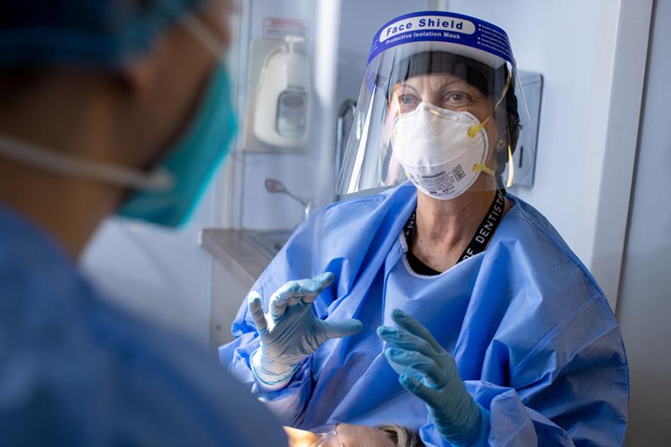 Dentists standing in front of imaging equipment