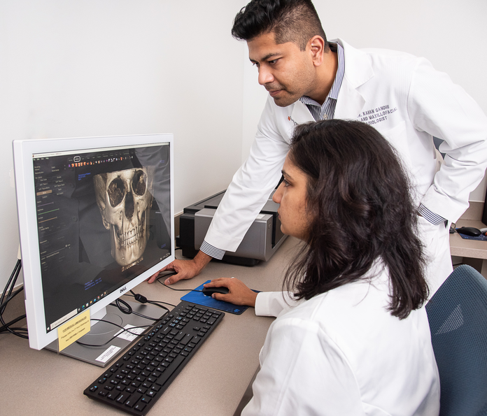 UT Dentists Doctor next to student staff